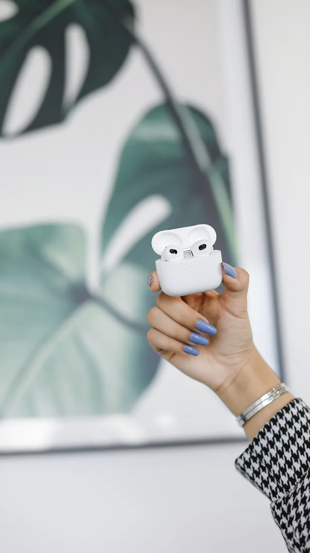 AirPods held in an everyday setting