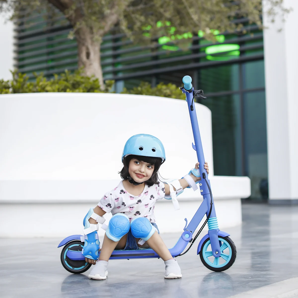Child riding a scooter outdoors